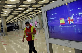 ep archivo   un operario de iberia pasa al lado de un monitor con las banderas de espana y reino