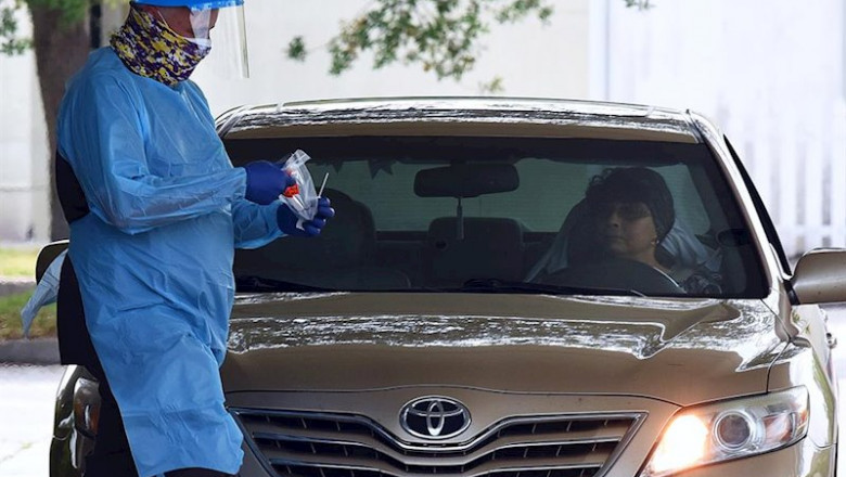 April 8, 2020 - Melbourne, Florida, United States - A healthcare worker wearing personal protection equipment prepares to administer a coronavirus test to a woman in a car on the second day of a drive-thru COVID-19 test collection facility operated by Omn | Paul Hennessy ep april 8 2020 - melbourne florida united states - a healthcare worker wearing personal protection