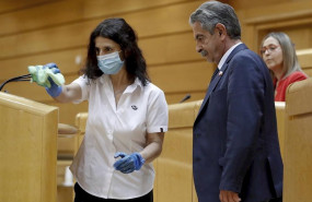 ep una trabajadora limpia los microfonos de la tribuna junto al presidente de cantabria miguel angel