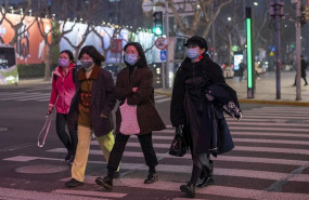 ep february 25 2020 - shanghai china pedestrians wear surgical masks as protection against the