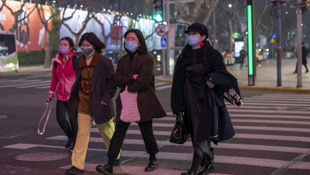 ep february 25 2020 - shanghai china pedestrians wear surgical masks as protection against the