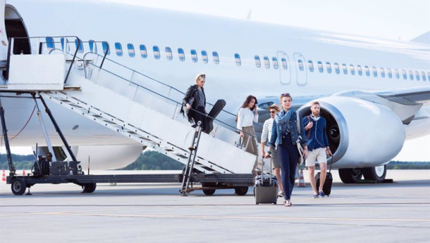 ep people disembarking a flight at commercial airport terminal group of people leaving the airplane