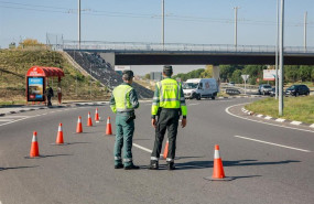 ep dos agentes de la guardia civil de trafico en medio de la carretera durante la campana especial