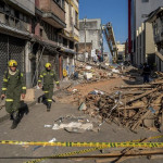 ep first responders walk down a rubble strewn street after mondays earthquake in pereira colombia on
