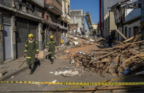 ep first responders walk down a rubble strewn street after mondays earthquake in pereira colombia on