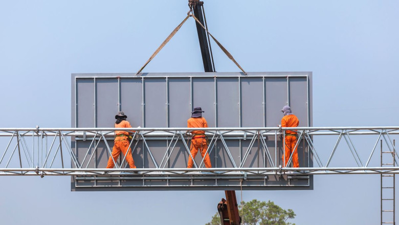 construction workers on billboard catwalk 1