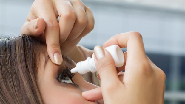 ep woman using eye drop eye lubricant to treat dry eye or allergy