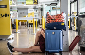 ep un joven miramovil sentadoamaleta juntopuestola compania vuelingaeropuerto josep tarradellas barcelona-prat durantehuelgapersonaltierraiberiabarcelona